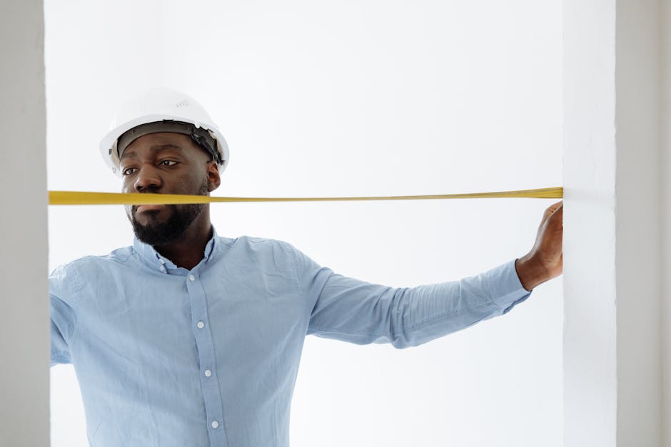 Smiling bathroom remodeling contractor reviewing plans